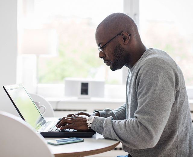 A person is typing something on a laptop.